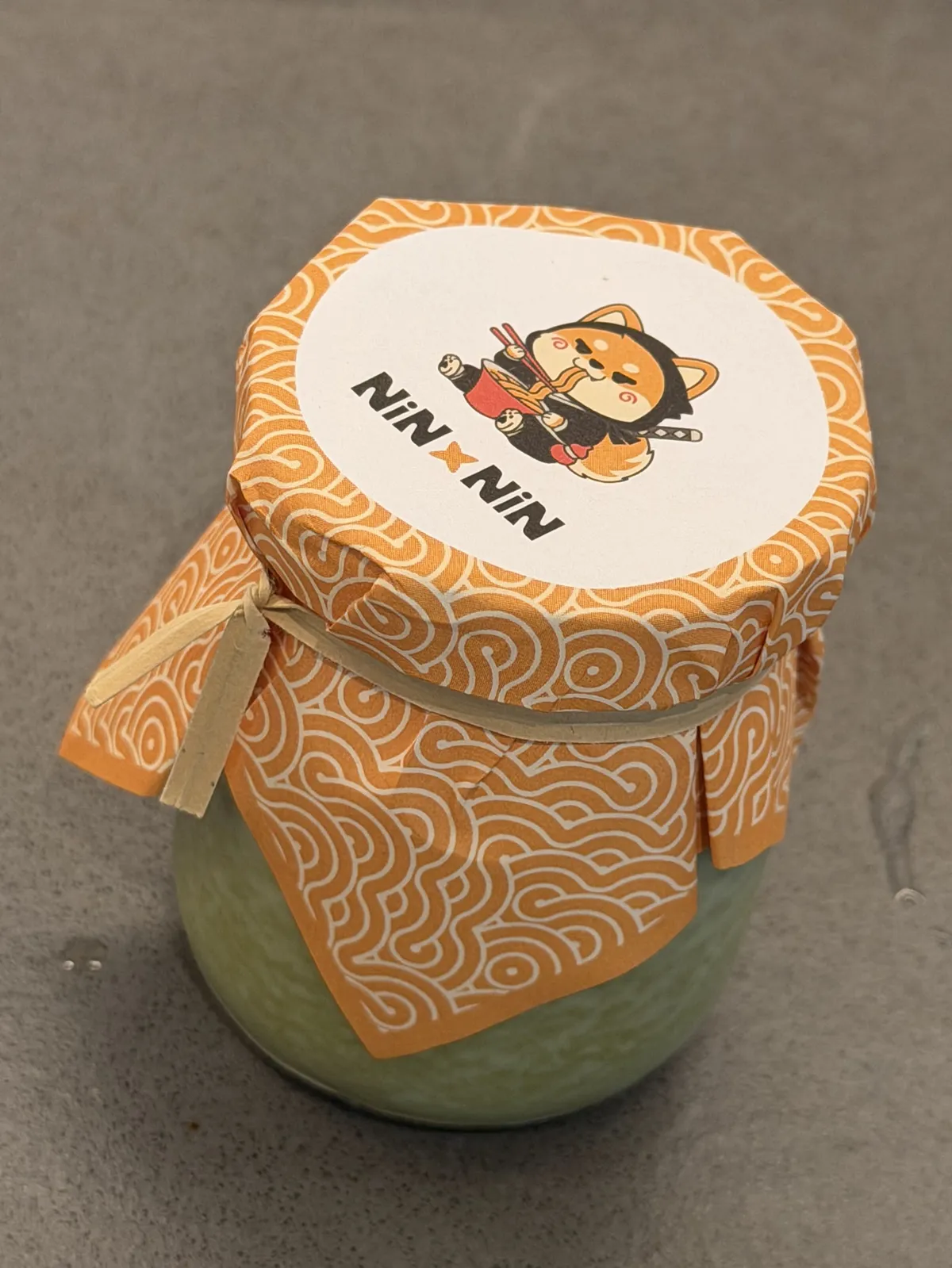 Jar of food with a "Nin x Nin" label
